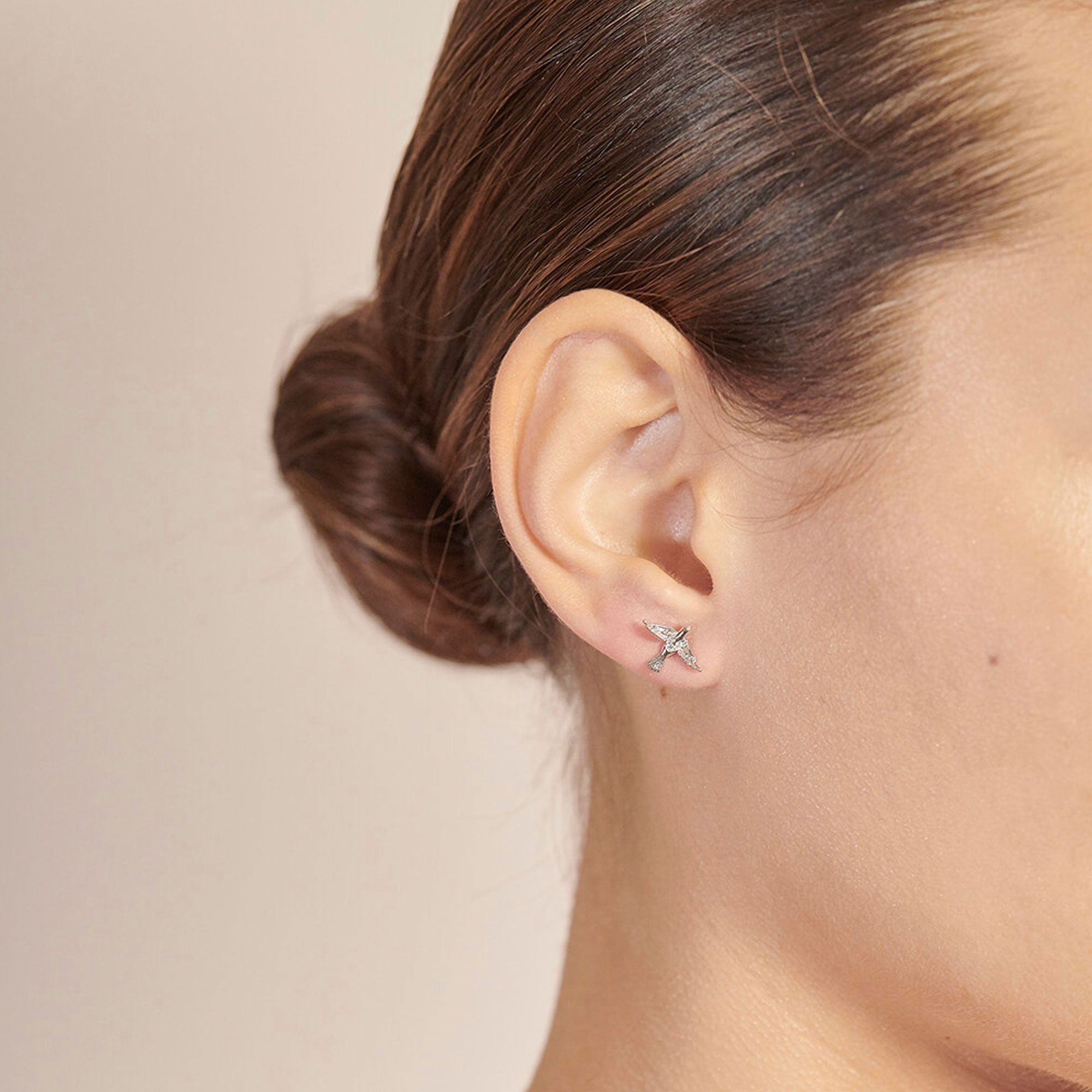 bird earrings in silver in ear